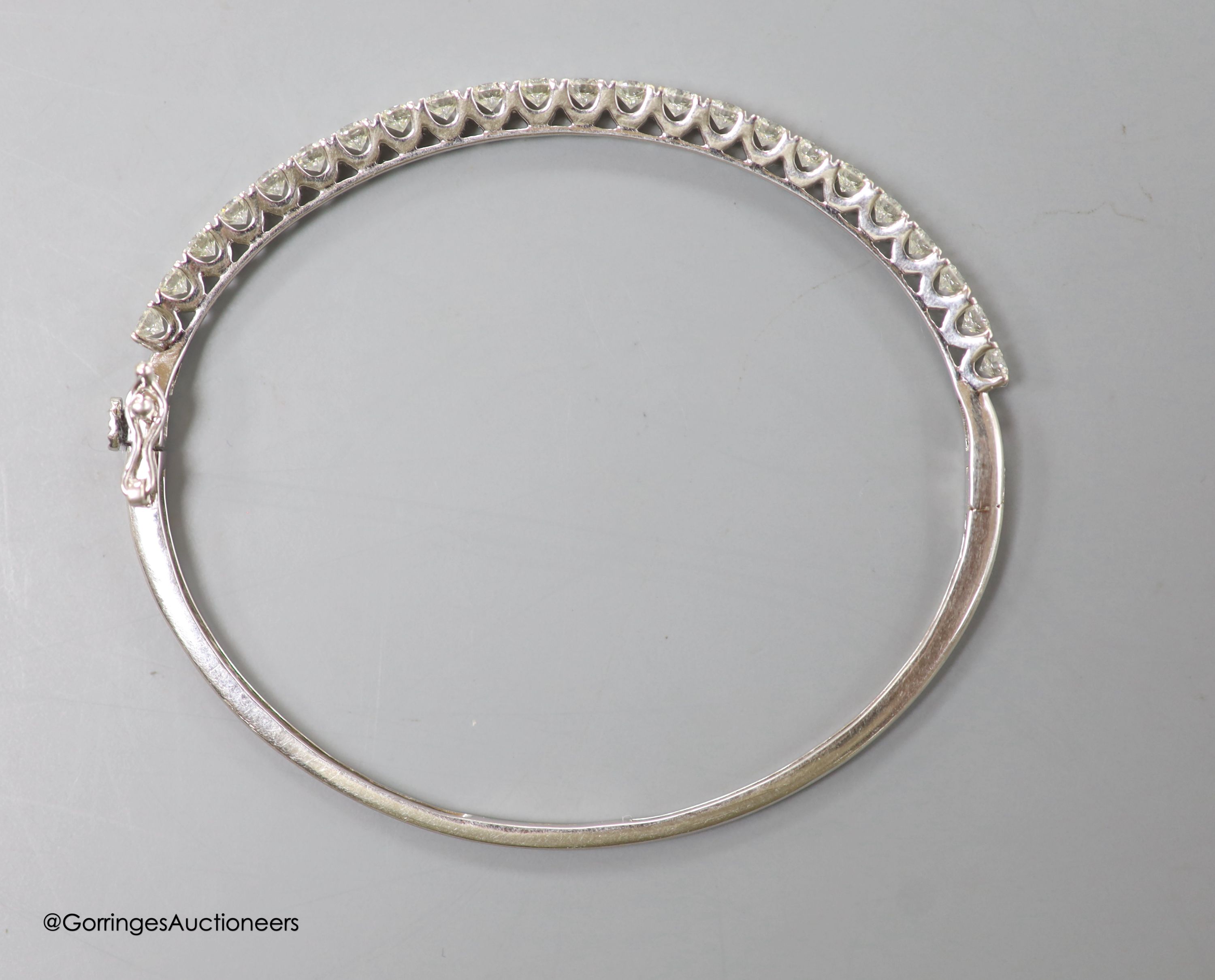 A modern 18ct white gold and twenty three stone diamond set hinged bracelet, gross 9.2 grams